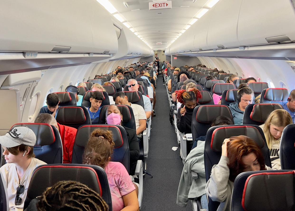 Passengers sit on board an airplane as they travel from to Washington, D.C., on July 2, 2022.