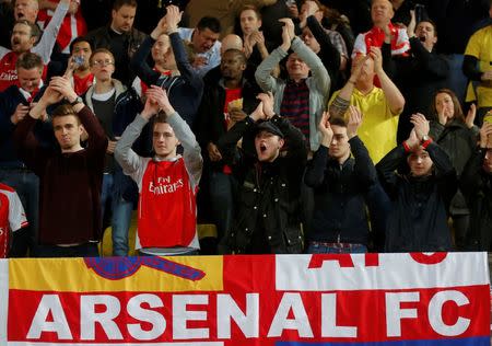 Arsenal fans cheer on their team at the start of the Champions League round of 16 second leg soccer match against AS Monaco at the Louis II Stadium in Monaco, March 17, 2015. REUTERS/Jean-Paul Pelissier