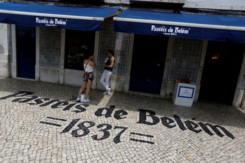 FILE PHOTO: Tourists take pictures at the Pasteis de Belem cafe in Lisbon
