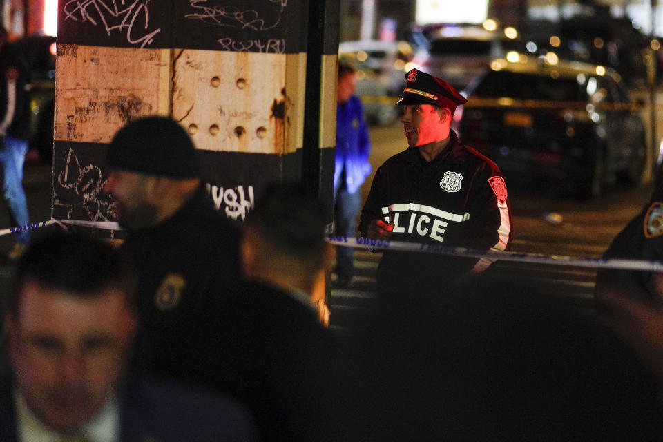 New York City Police officers gather following a shooting at the Mount Eden Avenue subway station, Monday, Feb. 12, 2024, in the Bronx borough of New York. (AP Photo/Eduardo Munoz Alvarez)