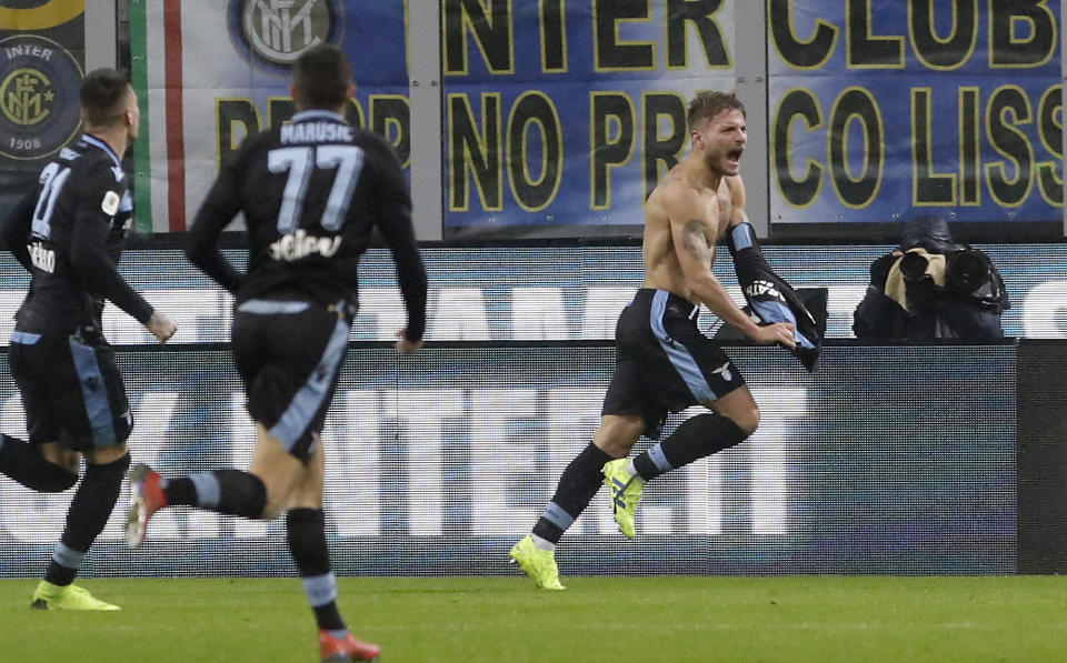 Lazio's Ciro Immobile, right, celebrates after scoring his side's opening goal during an Italian Cup quarterfinal soccer match between Inter Milan and Lazio at the San Siro stadium, in Milan, Italy, Thursday, Jan. 31, 2019. (AP Photo/Luca Bruno)