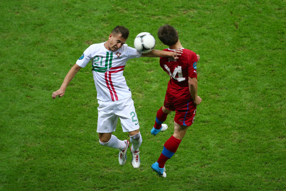 WARSAW, POLAND - JUNE 21: Joao Pereira of Portugal and Vaclav Pilar of Czech Republic jump for the ball during the UEFA EURO 2012 quarter final match between Czech Republic and Portugal at The National Stadium on June 21, 2012 in Warsaw, Poland. (Photo by Michael Steele/Getty Images)