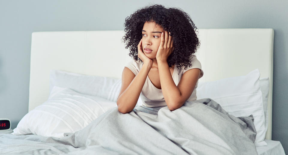 Woman with hangover anxiety in bed. (Getty Images)