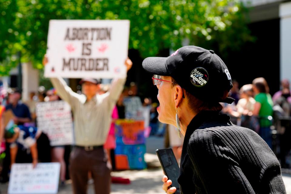 A woman supporting abortion rights shouts at anti-abortion protesters outside the South Carolina Statehouse on July 7 in Columbia, S.C.