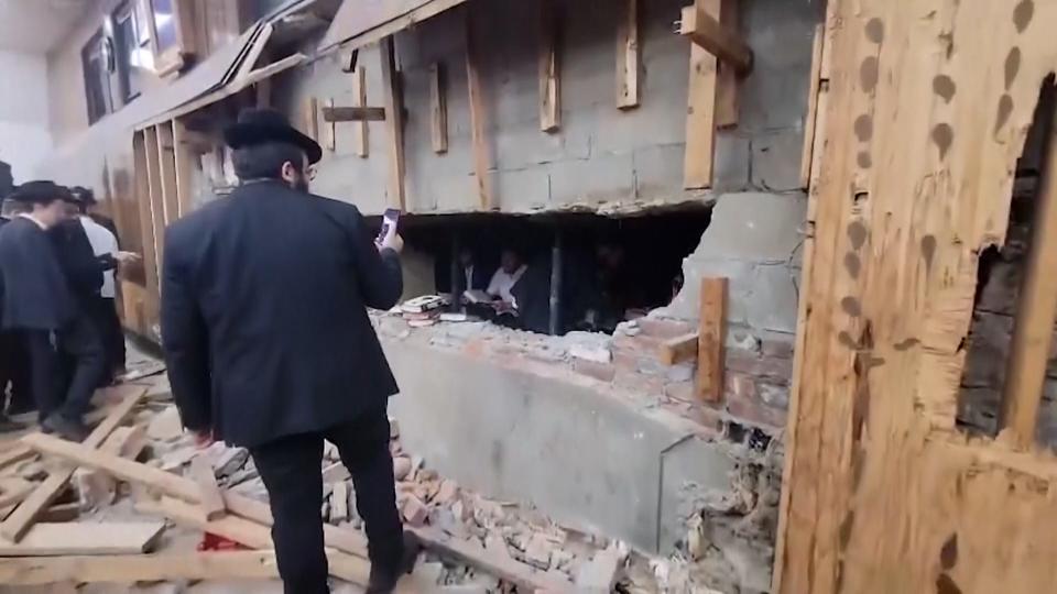 Members of a Jewish synagogue inspect a recently discovered secret tunnel under the place of worship.