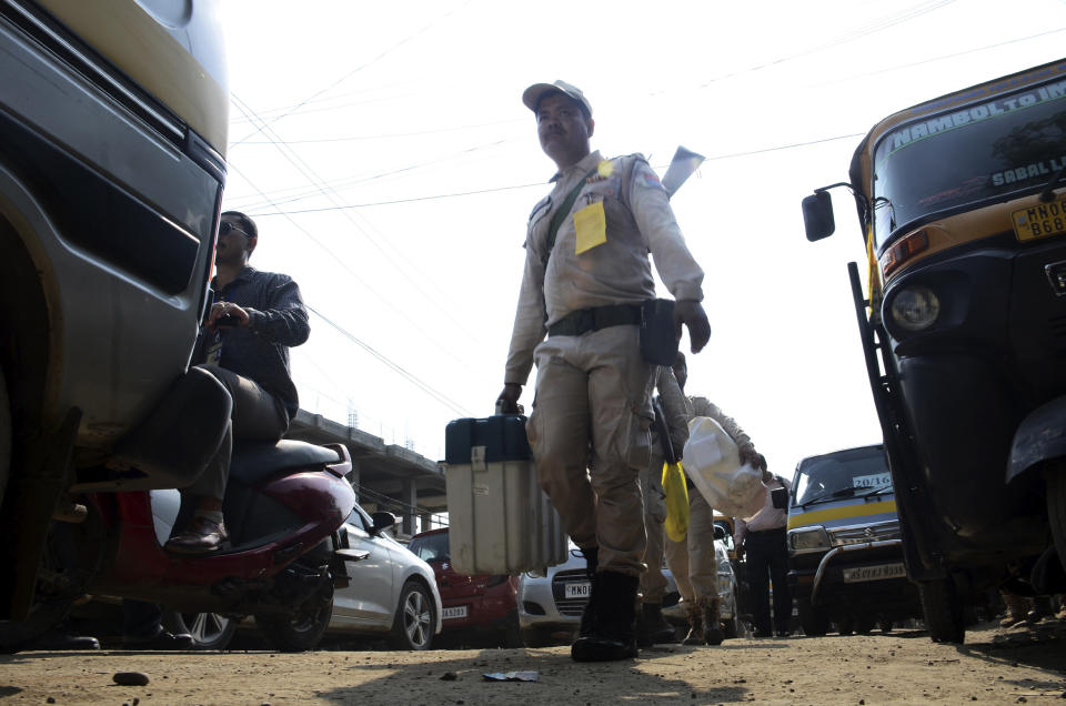 Security personnel carry Electronic Voting Machines (EVMs) and other election material to a polling booth on the eve of the national election in Inner Manipur Parliamentary Constituency, Imphal West district, in Manipur, India, Thursday, April 18, 2024. (AP Photo/Bullu Raj)