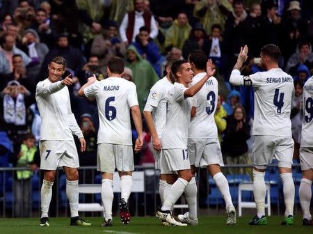 Football Socer - Real Madrid v Sporting Gijon - Spanish La Liga Santander - Santiago Bernabeu Stadium, Madrid, Spain - 26/11/16. Real Madrid's Cristiano Ronaldo (L) celebrates scoring with teammates. REUTERS/Susana Vera