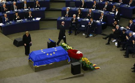 German Chancellor Angela Merkel pays respect in front of the coffin of late former German Chancellor Helmut Kohl during of a memorial ceremony at the European Parliament in Strasbourg, France, July 1, 2017. REUTERS/Arnd Wiegmann