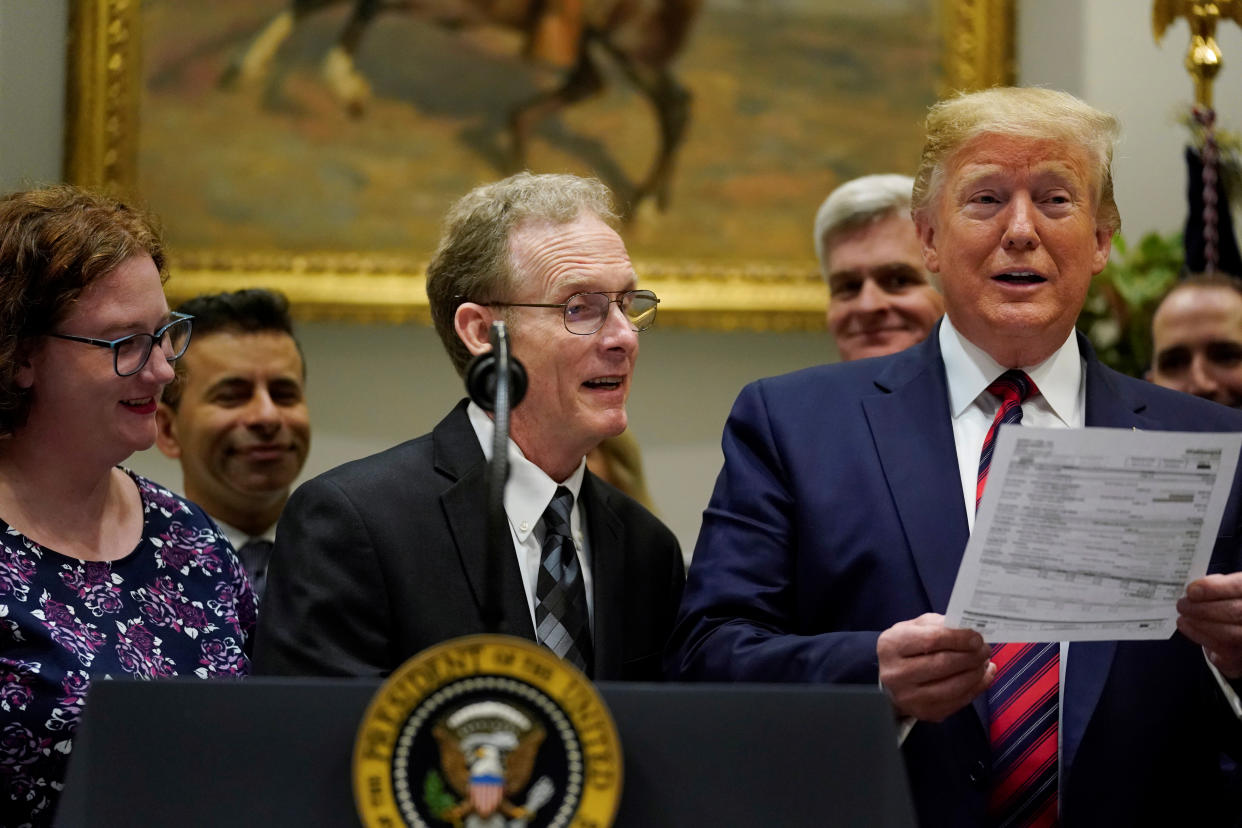 Dr. Paul Davis of Findlay, Ohio, shows U.S. President Donald Trump a surprise $17,000 medical bill his daughter received for a routine test, while Trump spoke to reporters about his support for proposed legislation to curb surprise medical bills at the White House in Washington, U.S. May 9, 2019.  REUTERS/Jonathan Ernst