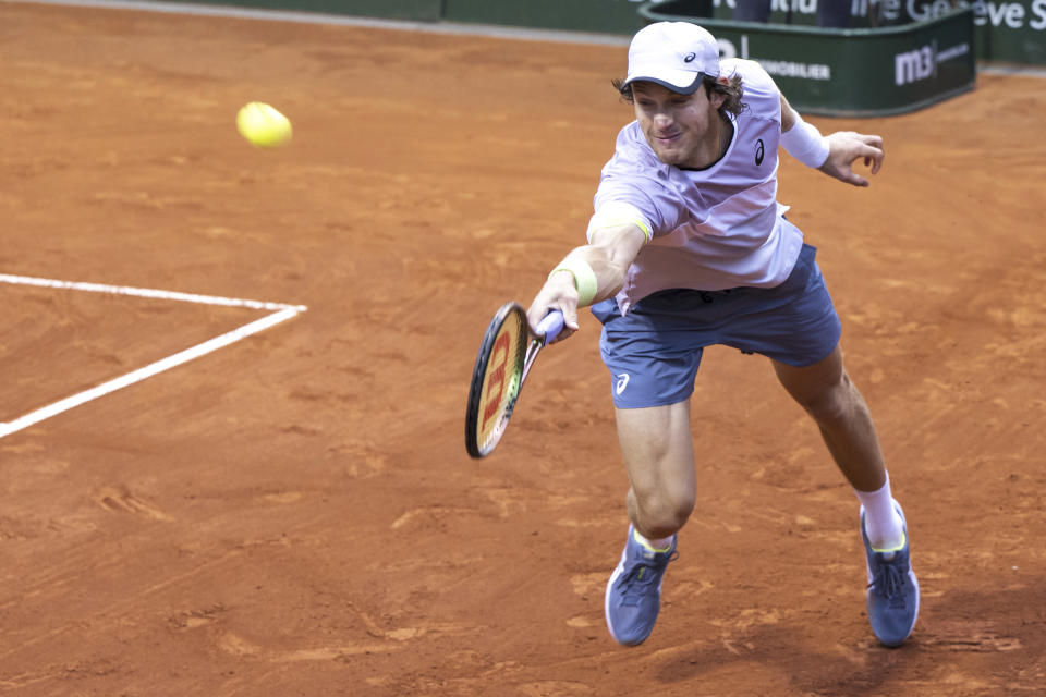 Nicolas Jarry of Chile returns a ball to Casper Ruud of Norway during their quarter-final match at the Geneva Open tennis tournament in Geneva, Switzerland, Thursday, May 25, 2023. (Martial Trezzini/Keystone via AP)