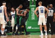 Apr 7, 2019; Boston, MA, USA; Boston Celtics guard Marcus Smart (36) is helped off the court by center Al Horford (42) after hurting his oblique during the second half against the Orlando Magic at TD Garden. Mandatory Credit: Bob DeChiara-USA TODAY Sports