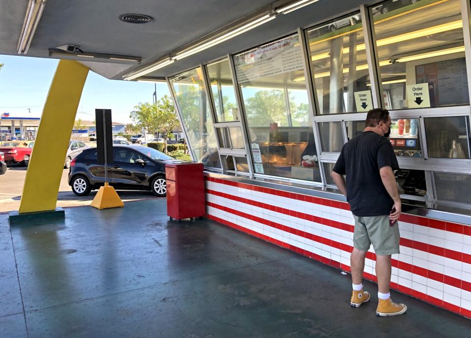 Sam Pocker places an order at a fast-food window