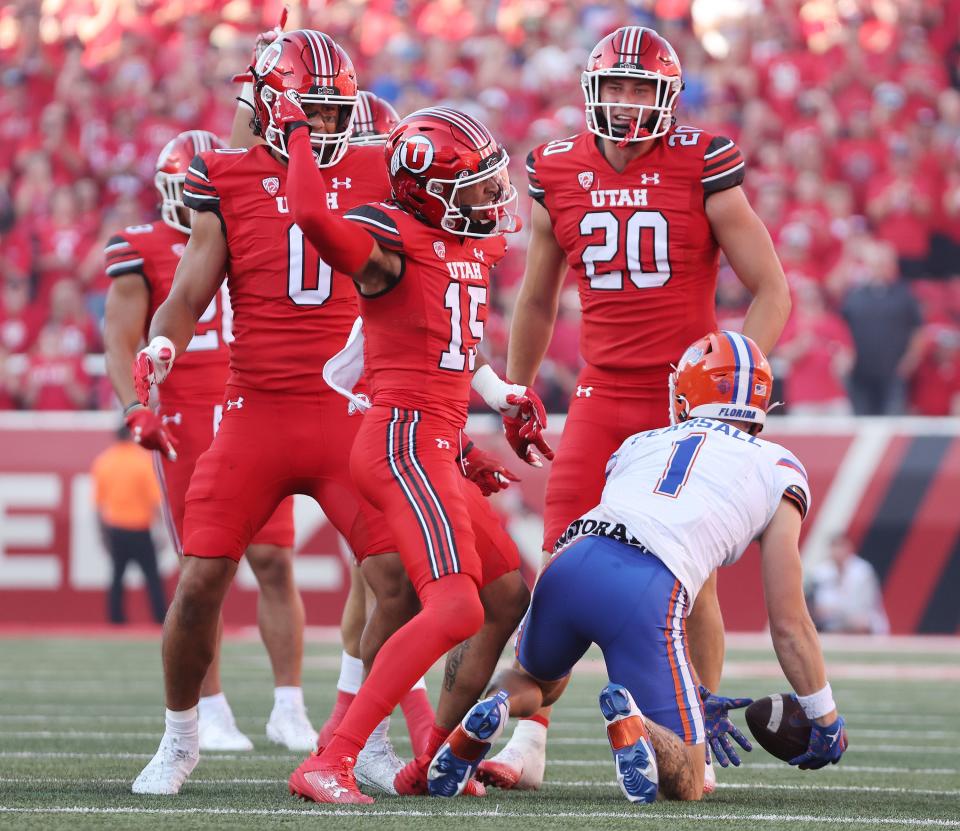 Utah Utes cornerback Tao Johnson (15) makes a tackle for a loss against Florida Gators wide receiver Ricky Pearsall (1) in Salt Lake City on Thursday, Aug. 31, 2023 during the season opener. Utah won 24-11.