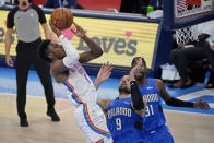 Oklahoma City Thunder guard Hamidou Diallo (6) shoots in front of Orlando Magic center Nikola Vucevic (9) and guard Terrence Ross (31) during the second half of an NBA basketball game Tuesday, Dec. 29, 2020, in Oklahoma City. (AP Photo/Sue Ogrocki)