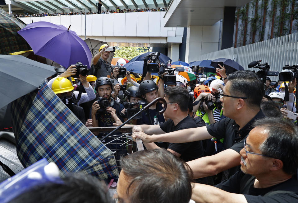 In this July 1, 2019, photo, pro-democracy lawmaker Lam Cheuk-ting, right top, who tried to stop Hong Kong protesters from breaking into the legislature, Lam says China will likely use the vandalizing of the building as a reason to step up pressure on the semi-autonomous Chinese territory. (AP Photo/Vincent Yu)