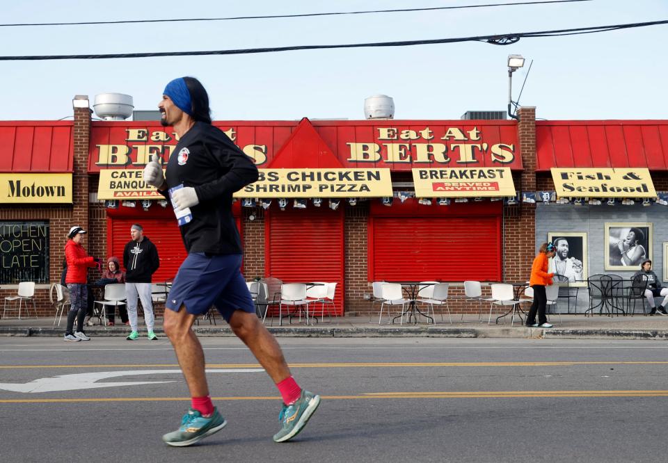 A marathon runner passes by the well know Bert's restaurant at Eastern Market on Russell Street during the 45th Annual Detroit Free Press Marathon in Detroit on Sunday, Oct. 16, 2022.