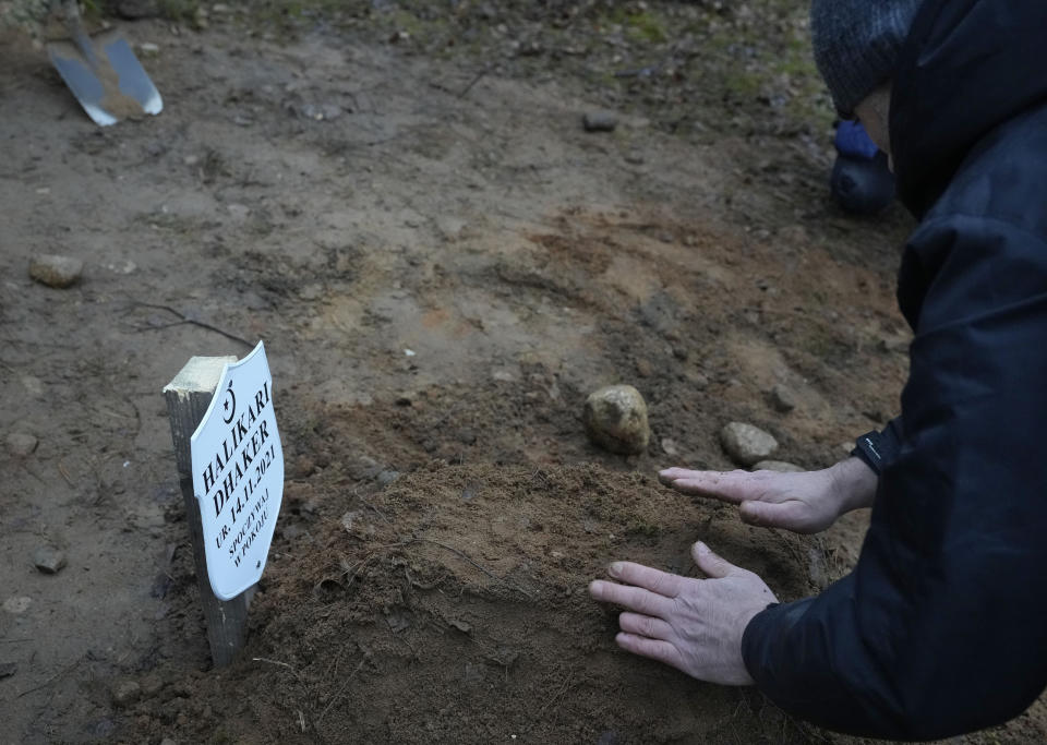 Two members of a Muslim community bury the tiny white casket of an unborn Iraqi boy, in Bohoniki, Poland, on Tuesday Nov. 23, 2021. The child is the latest life claimed as thousands of migrants from the Middle East have sought to enter the European Union but found their path cut off by a military build-up and fast approaching winter in the forests of Poland and Belarus. (AP Photo/Czarek Sokolowski)