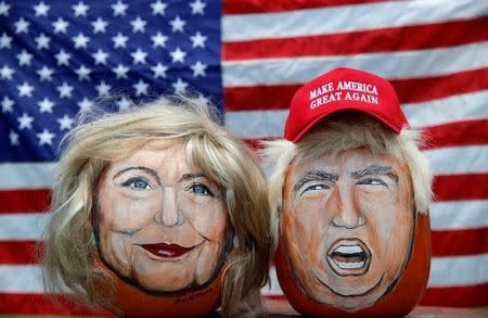 The images of U.S. Democratic presidential candidate Hillary Clinton (L) and Republican Presidential candidate Donald Trump are seen painted on decorative pumpkins created by artist John Kettman in LaSalle, Illinois, U.S., June 8, 2016. REUTERS/Jim Young
