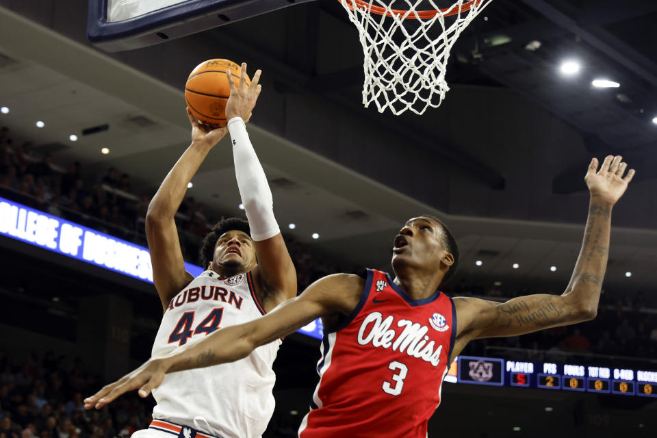 Auburn center Dylan Cardwell (44) shoots over Mississippi forward Jamarion Sharp (3) during the second half of an NCAA college basketball game Saturday, Jan. 20, 2024, in Auburn, Ala. (AP Photo/Butch Dill)