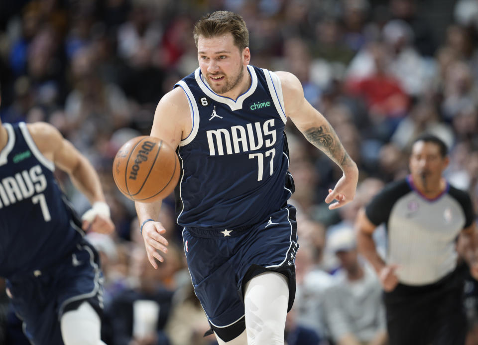 Dallas Mavericks guard Luka Doncic pursues a loose ball in the first half of an NBA basketball game against the Denver Nuggets Wednesday, Feb. 15, 2023, in Denver. (AP Photo/David Zalubowski)