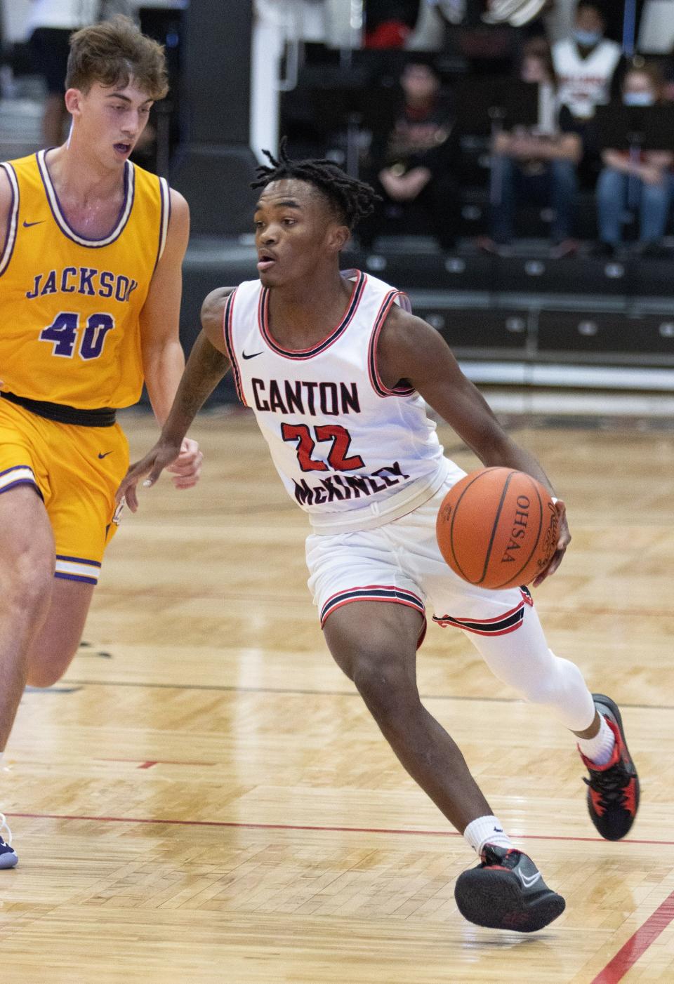 McKinley’s Tra'Sean Foster brings the ball down court against Jackson’s Colby Johnson on Saturday, Jan. 8, 2022.