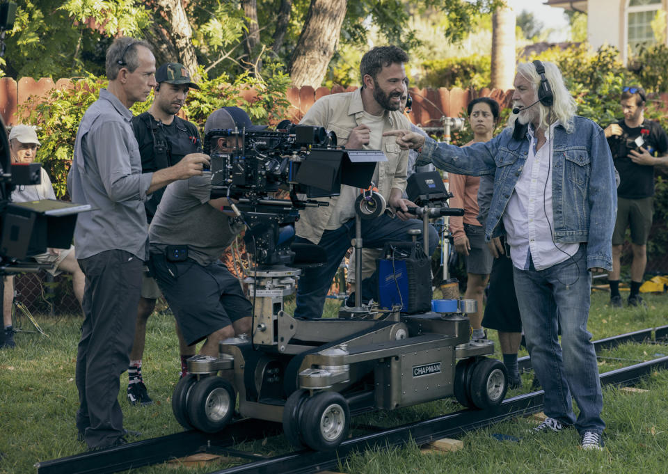 This image released by Amazon Prime Video shows director Ben Affleck, seated center, on the set of "Air." (Ana Carballosa/Amazon Prime Video via AP)