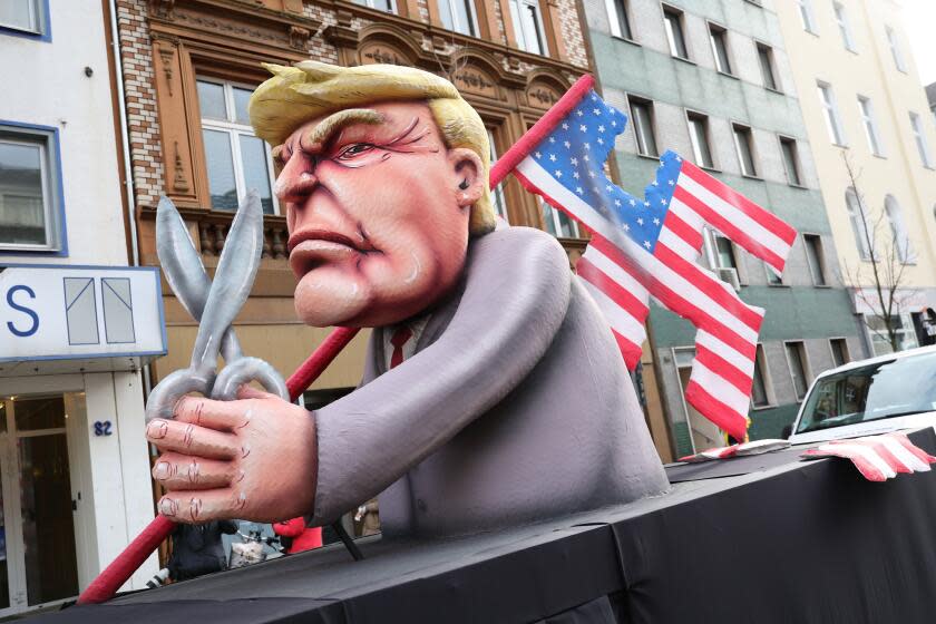 DUSSELDORF, GERMANY - FEBRUARY 12: A parade float shows an effigy of Donald Trump holding a pair of scissors in his hand with a cut-up US flag in the shape of a swastika at the annual Rose Monday Carnival parade on February 12, 2024 in Dusseldorf, Germany. The Mainz and Dusseldorf Rose Monday parades are known for their biting political satire. Cities in western Germany are celebrating the traditional Rhineland Carnival this week, culminating in today's Rose Monday parades. (Photo by Andreas Rentz/Getty Images)