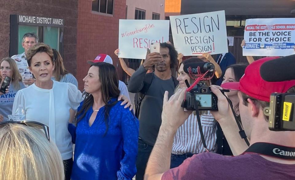 Kari Lake, a Republican candidate for governor, has her arm around Scottsdale parent Amanda Wray as people gather outside the Mohave District Annex before the Scottsdale Unified School District Governing Board meeting on Nov. 15, 2021. Lake and others called for the ouster of school board President Jann-Michael Greenburg.