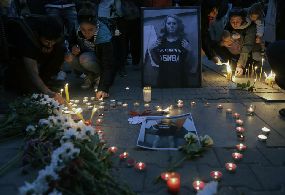 A portrait of the Bulgarian journalist Viktoria Marinova, killed in the northern town of Ruse, is seen during a vigil in Sofia, Monday, Oct. 8, 2018. Bulgarian police are investigating the rape, beating and slaying of a female television reporter whose body was dumped near the Danube River after she reported on the possible misuse of European Union funds in Bulgaria. (AP Photo/Valentina Petrova)