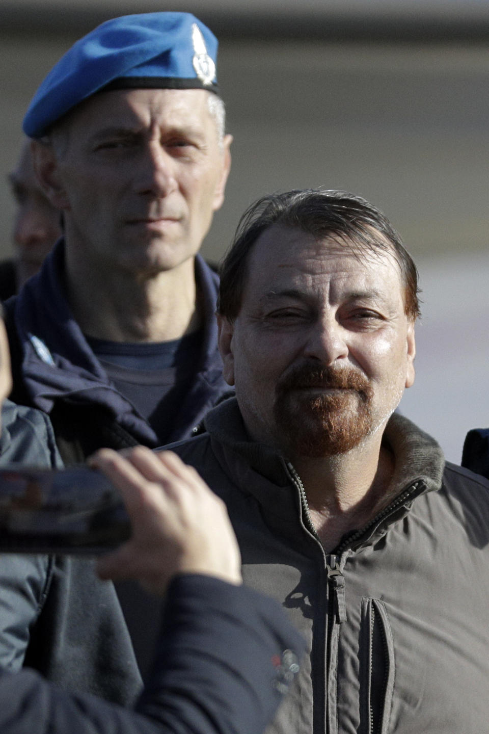 Italian fugitive Cesare Battisti arrives at Ciampino military airport, in Rome, Monday, Jan. 14, 2019. Battisti a left-wing Italian militant who was convicted of murder three decades ago is heading home to serve a life sentence, after his life as a celebrity fugitive came to an abrupt end with his arrest in Bolivia by a team of Interpol agents. (AP Photo/Gregorio Borgia)