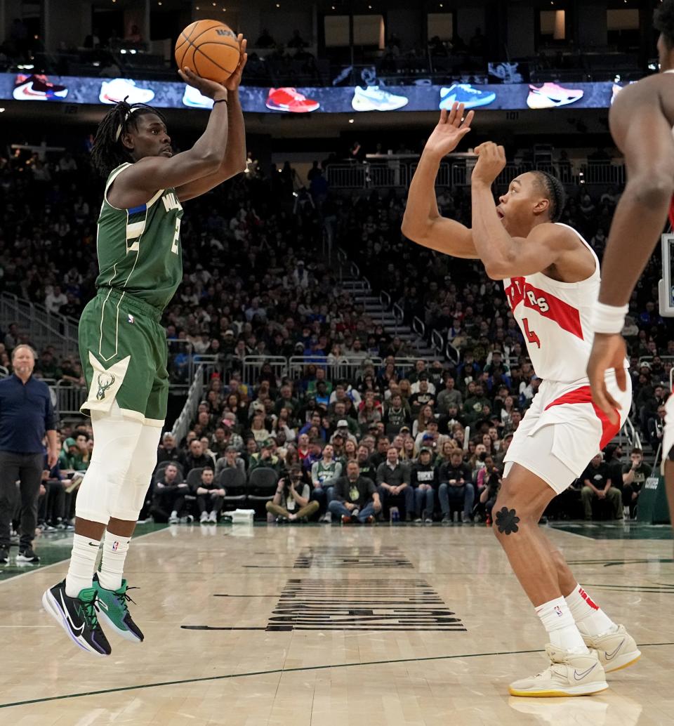 Bucks guard Jrue Holiday shoots over Raptors forward Scottie Barnes during the second half Tuesday night at Fiserv Forum.