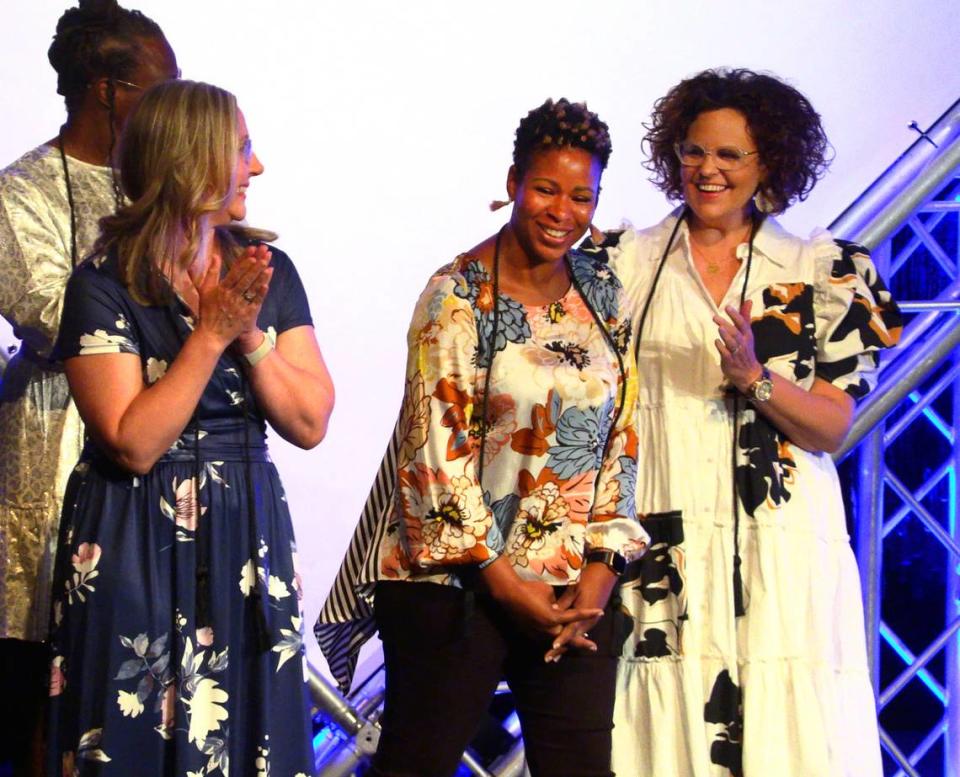 Malissa Jones, second from right, a biology and physics teacher at Jordan Vocational High School, was named the teaching category winner at the 2023 Page One Awards program at RiverCenter for the Performing Arts.