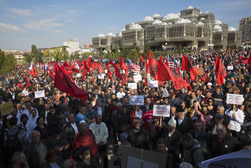 Thousands of supporters of Kosovo's opposition Self-Determination party hold banners and national Albanian flags as they march through the capital city of Pristina toward Skanderbeg Square on Saturday, Sept. 29, 2018. Thousands of people in Kosovo are protesting their president's willingness to include a possible territory swap with Serbia in the ongoing negotiations to normalize relations between the two countries.(AP Photo/Visar Kryeziu)