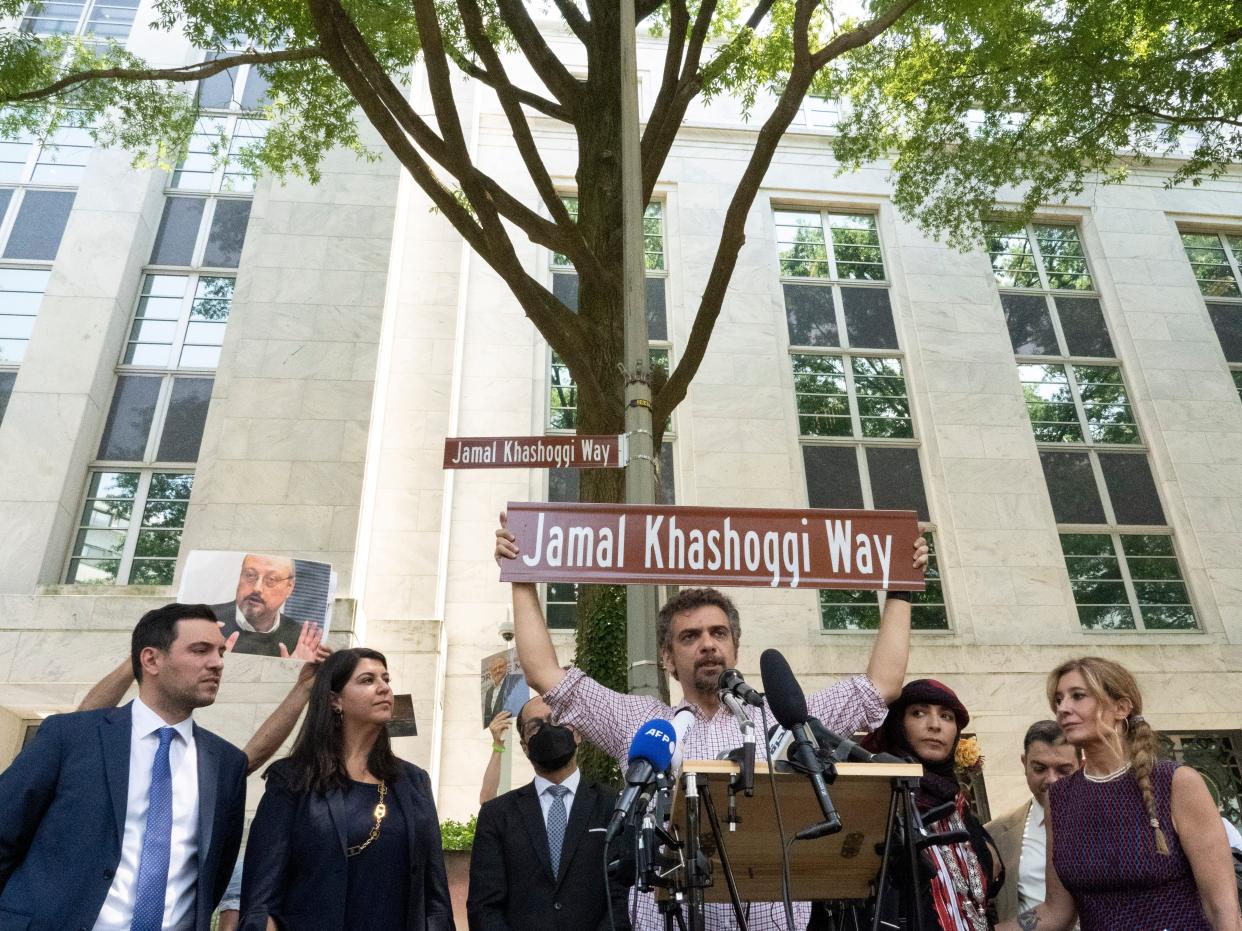 Participants stand for a group photo after unveiling a new street sign for Jamal Khashoggi Way outside of the Embassy of Saudi Arabia, Wednesday, June 15, 2022 in Washington.