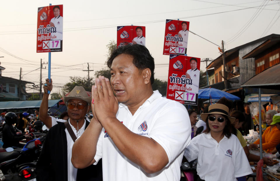 In this March 14, 2019, photo, Veerawit Chuajunud, center, who changed his name to Thaksin Chuajunud for Pheu Chart party, makes his election campaign in Nakhon Ratchasima, Thailand. Thailand’s former Prime Minister Thaksin Shinawatra is in exile and banned from interfering in the country’s politics. But his name is a powerful political attraction and in tribute, and to win votes, some candidates in general election on Sunday, March 24, 2019 have changed their names to Thaksin so supporters of the former leader can register their loyalty at the ballot box. (AP Photo/Sakchai Lalit)