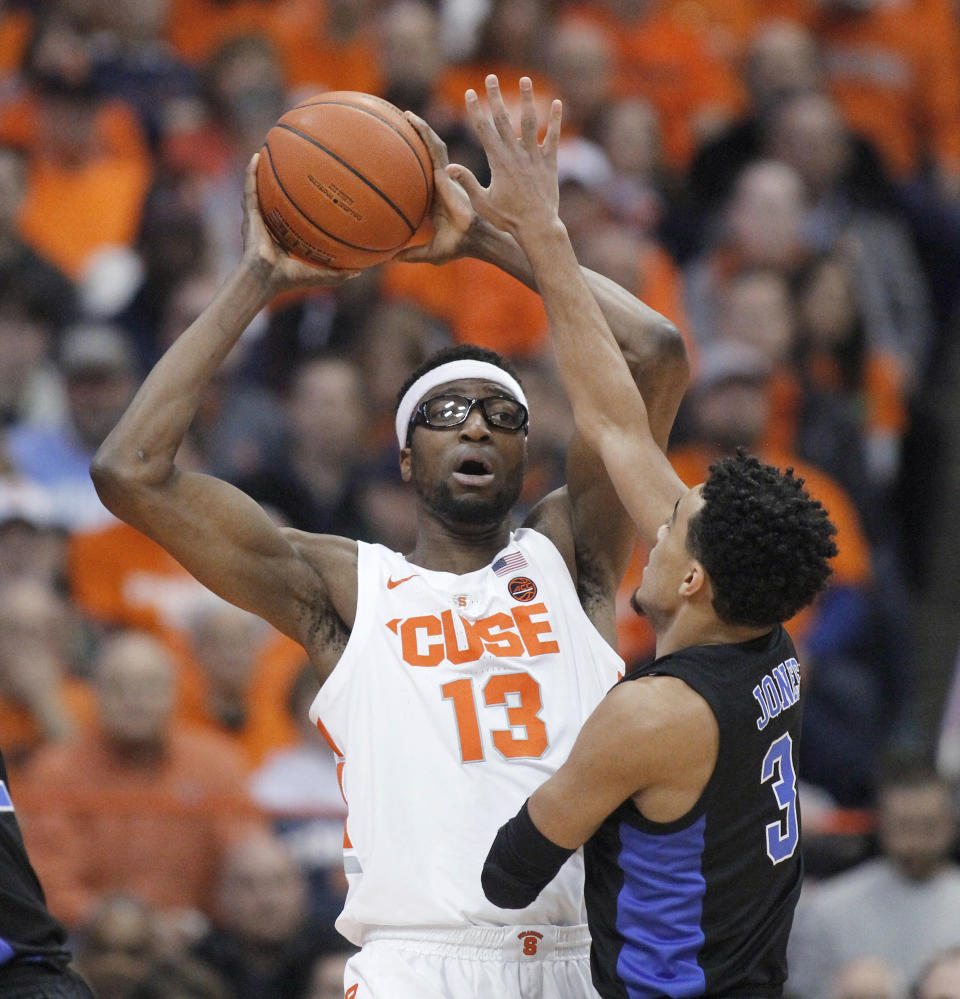 Syracuse's Paschal Chukwu, right, tries to pass the ball over Duke's Tre Jones, right, during the first half of an NCAA college basketball game in Syracuse, N.Y., Saturday, Feb. 23, 2019. (AP Photo/Nick Lisi)