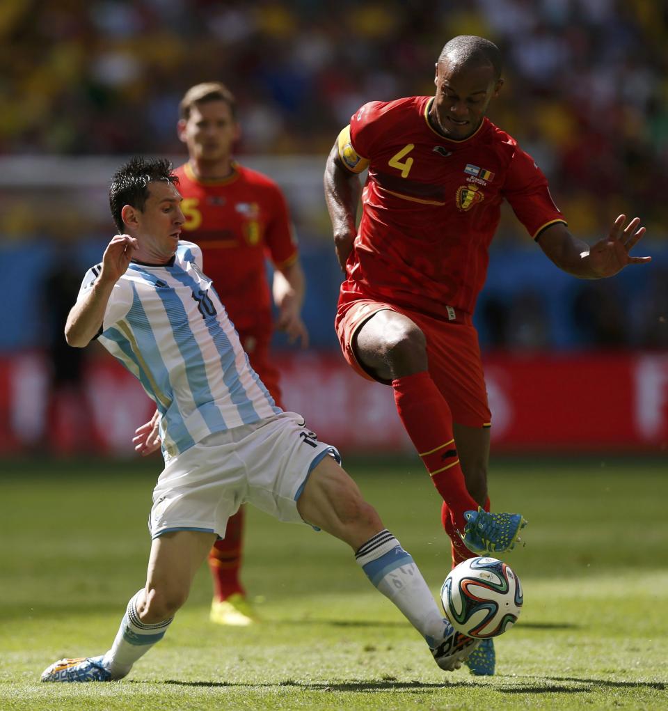 Argentina's Lionel Messi (10) fights for the ball with Belgium's Vincent Kompany during their 2014 World Cup quarter-finals at the Brasilia national stadium in Brasilia July 5, 2014. REUTERS/Ueslei Marcelino
