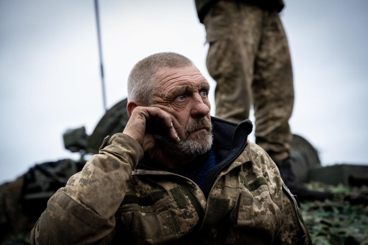 A Ukrainian soldier with the nickname Dragon shows the fatigue of months of fighting without a break, as the rest of the tank crew make adjustments to a captured Russian T-72B tank, as they drive it toward the northeastern Kharkiv region frontline on a road to Izyum, Ukraine, on September 28, 2022.