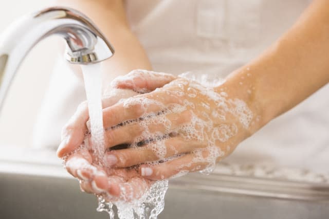 Caucasian woman washing her hands