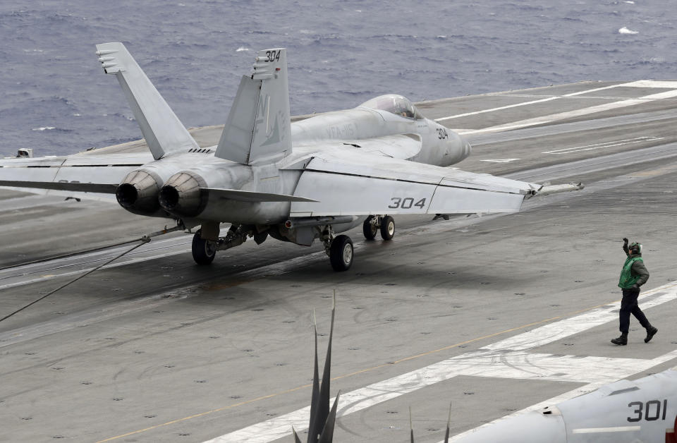 A U.S. fighter jet lands on the U.S. aircraft carrier USS Ronald Reagan following their patrol at the international waters off South China Sea Tuesday, Aug. 6, 2019. The USS Ronald Reagan is cruising in international waters in the South China Sea amid tensions in the disputed islands, shoals and reefs between China and other claimant-countries as Philippines, Vietnam and Malaysia. (AP Photo/Bullit Marquez)