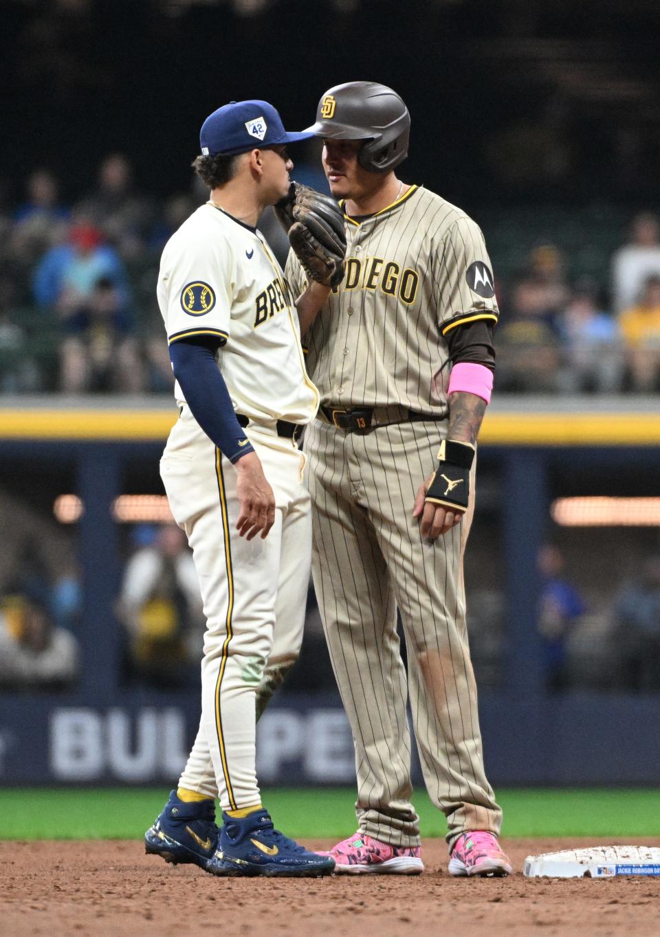 Apr 15, 2024; Milwaukee, Wisconsin, USA; Milwaukee Brewers shortstop Willy Adames (27) and San Diego Padres third base Manny Machado (13) have a talk at second base during the fifth inning at American Family Field. All players wore #42 in honor of Jackie Robinson Day. Mandatory Credit: Michael McLoone-USA TODAY Sports