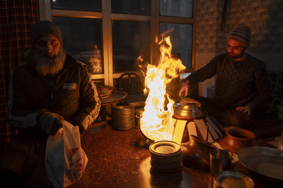 Asim Ahmed prepares 'Harisa' before serving it to customers in Srinagar, Indian controlled Kashmir, Wednesday, Jan. 3, 2024. Harisa is a winter dish which is sold early mornings at specially setup shops, called Harisa Wan. (AP Photo/Dar Yasin)