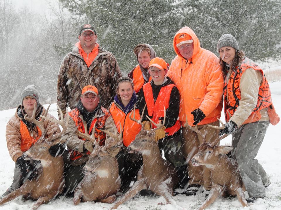 The extended Schott family pose with their deer in 2013 after a successful hunt.