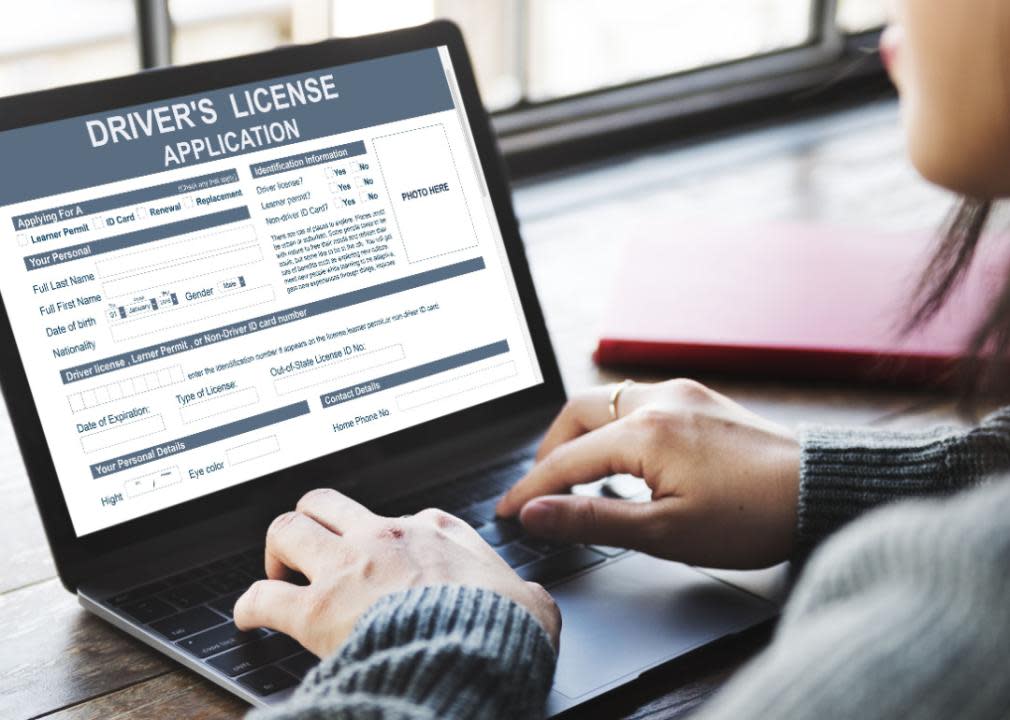 Person filling out driver’s license application form.