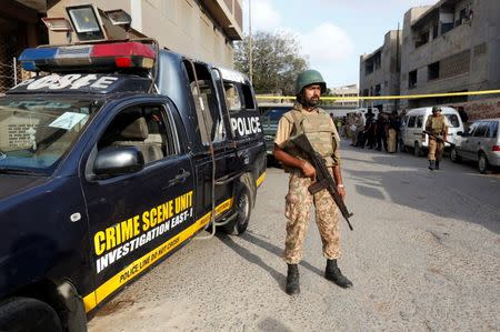 A paramilitary soldier stands guard at the site after two army personnel were killed by attackers on a motorcycle in Karachi, Pakistan, July 26, 2016. REUTERS/Akhtar Soomro