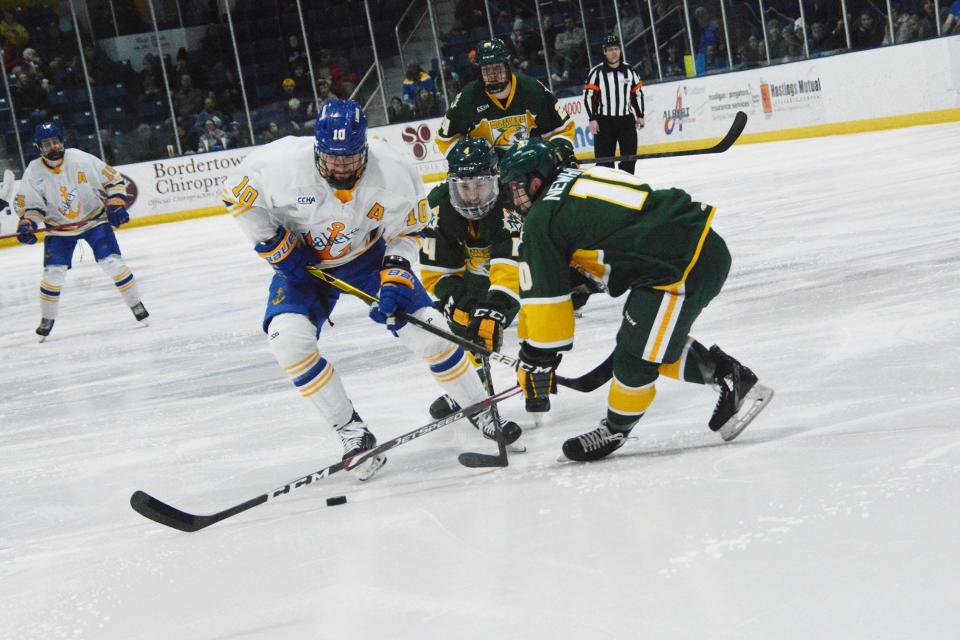 Lake Superior State's Miroslav Mucha (10) competes for the puck against Northern Michigan's Ben Newhouse (10) and Michael Van Unen (4) during a CCHA quarterfinal Sunday at Taffy Abel Arena.