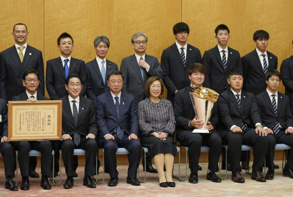 Japan's World Baseball Classic (WBC) team manager Hideki Kuriyama, left front, and players meet Japanese Prime Minister Fumio Kishida, second left front, at Kishida's official residence in Tokyo, Japan, Thursday, March 23, 2023. Japan won over the U.S. at the WBC final Tuesday. Slugger Munetaka Murakami, third right front, holds the WBC trophy.(Kimimasa Mayama/Pool Photo via AP)