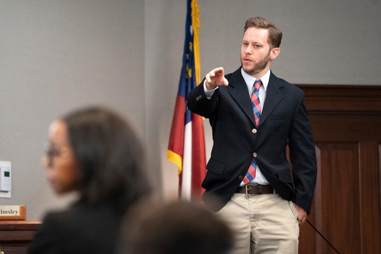 Former Glynn County police officer Ricky Minshew points out defendant Travis McMichael during the trial in the shooting death of Ahmaud Arbery at the Glynn County Courthouse on  Nov. 8 in Brunswick, Ga.