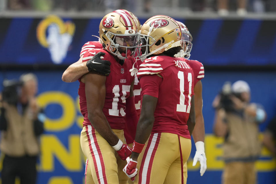 San Francisco 49ers wide receiver Jauan Jennings, left, is congratulated by teammates after scoring against the Los Angeles Rams during the first half of an NFL football game, Sunday, Sept. 22, 2024, in Inglewood, Calif. (AP Photo/Ashley Landis)