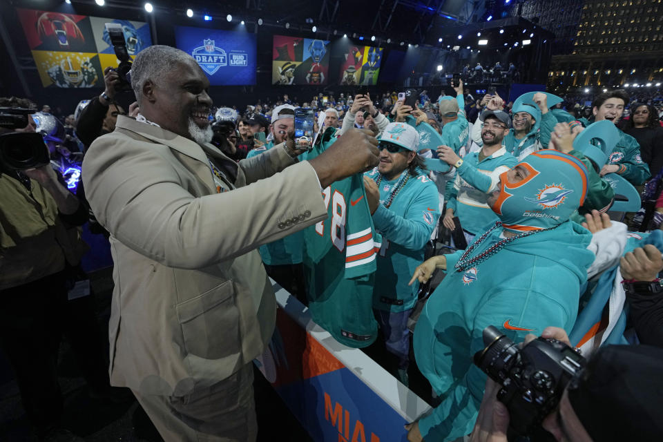 Former player Richmond Webb meets with Miami Dolphins fans during the second round of the NFL football draft, Friday, April 26, 2024, in Detroit. (AP Photo/Paul Sancya)